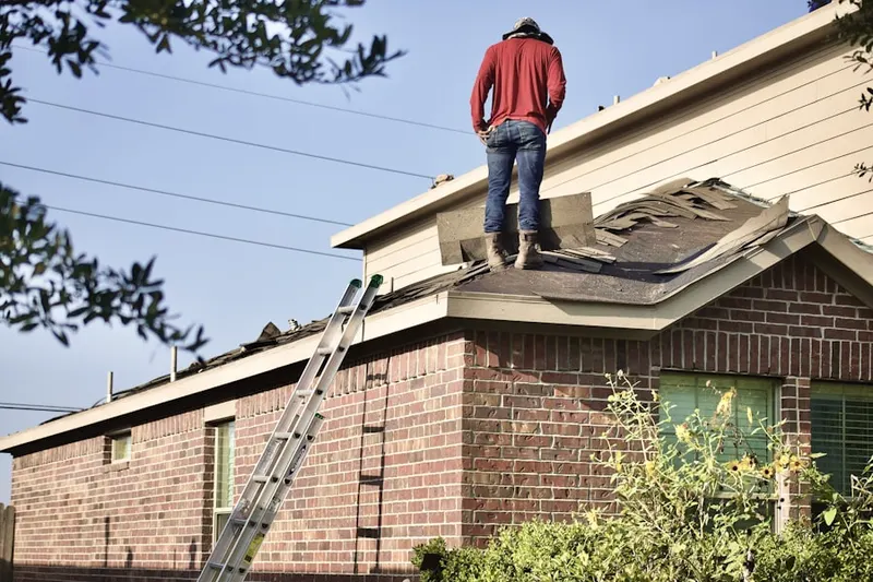 Professional roofer working on a residential roof in Orchard Point at Piney Orchard